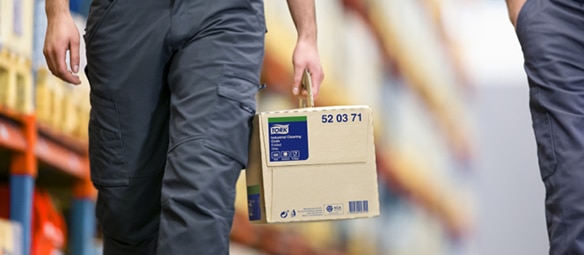 Close up of a man’s hand carrying a package