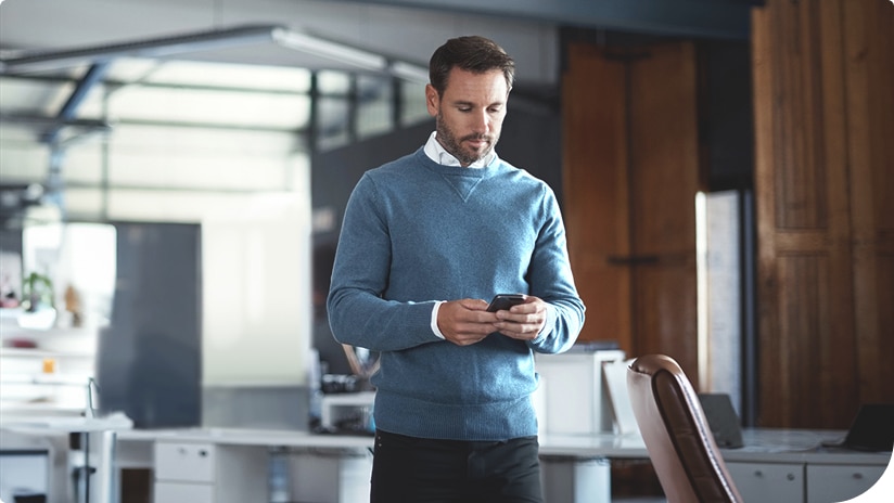 A facility manager using a smartphone for facility data A facility manager using a smartphone for facility data