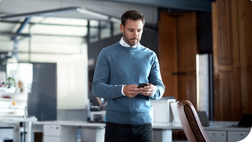 A facility manager using a smartphone for facility data A facility manager using a smartphone for facility data