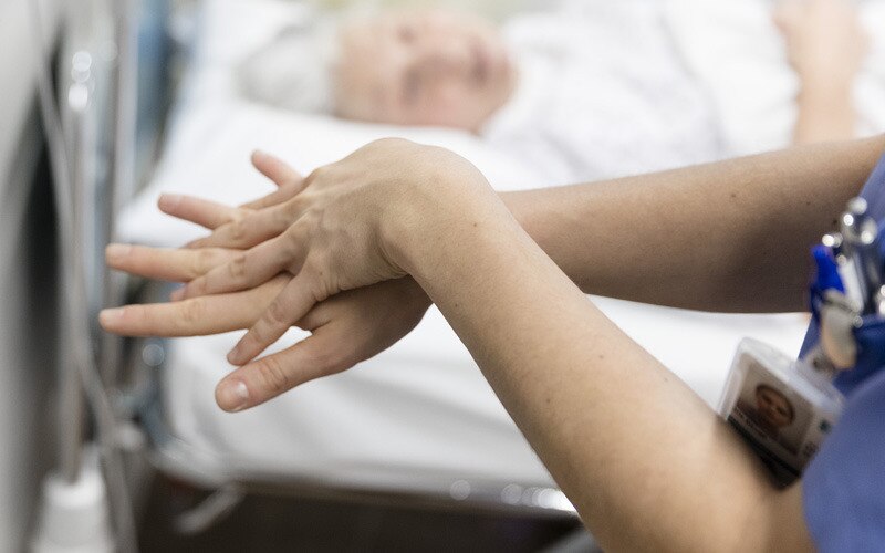 Person, die sich die Hände mit Wasser und Seife wäscht