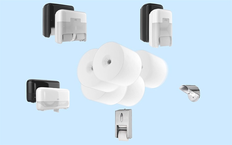 Image of one wide range of Tork OptiServe commercial coreless toilet paper dispensers and coreless toilet rolls