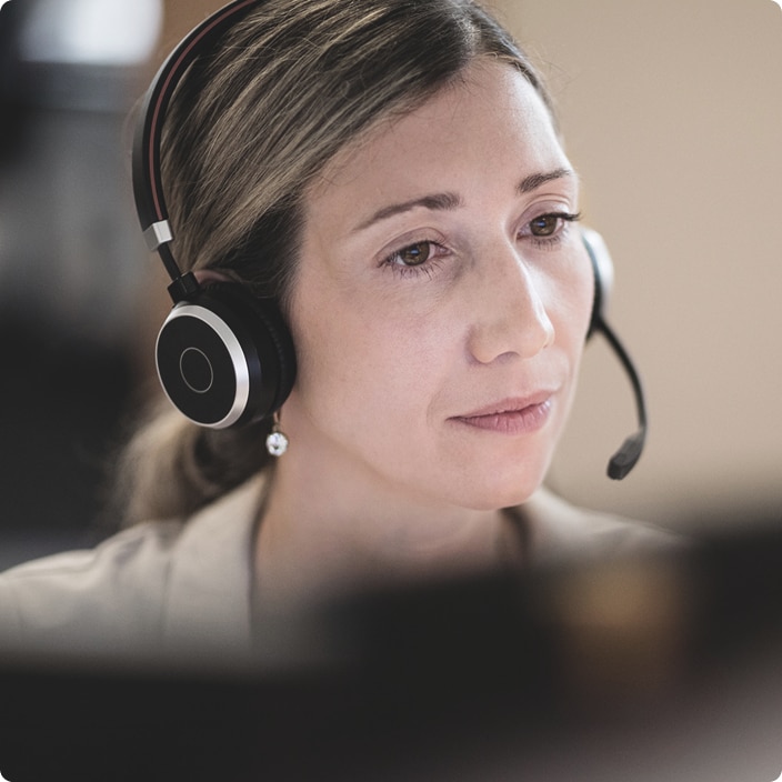 Customer service agent wearing a headset and speaking during a call