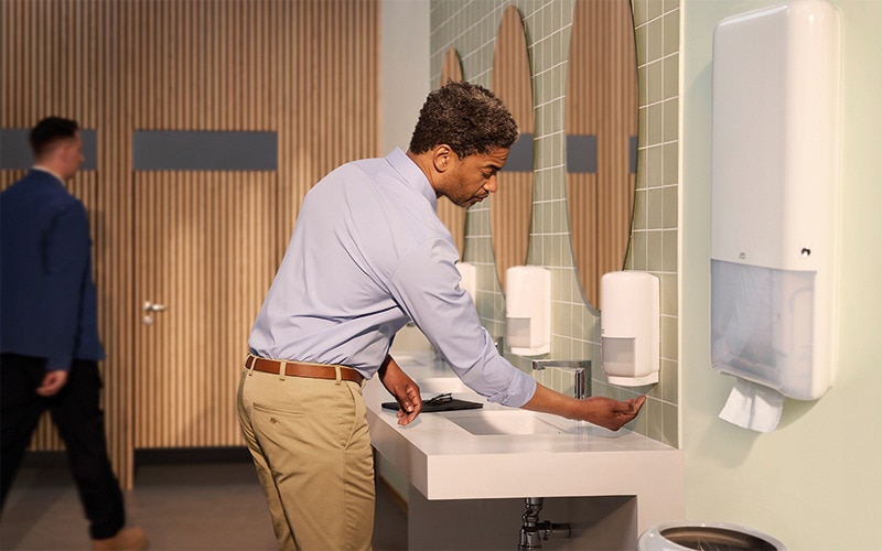 Man washing hands in a bathroom