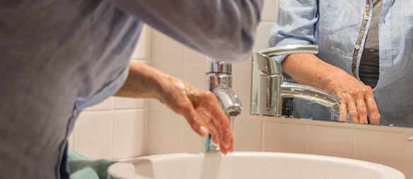 Older woman washing her hands​