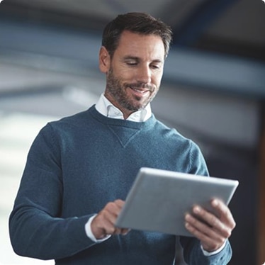 A facility manager using a tablet in a professional setting A facility manager using a tablet in a professional setting