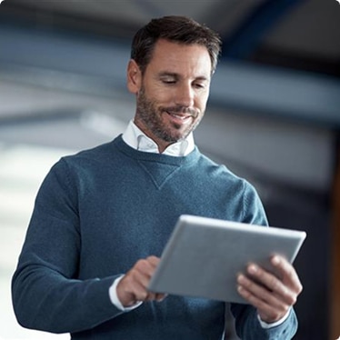 A facility manager using a tablet in a professional setting A facility manager using a tablet in a professional setting