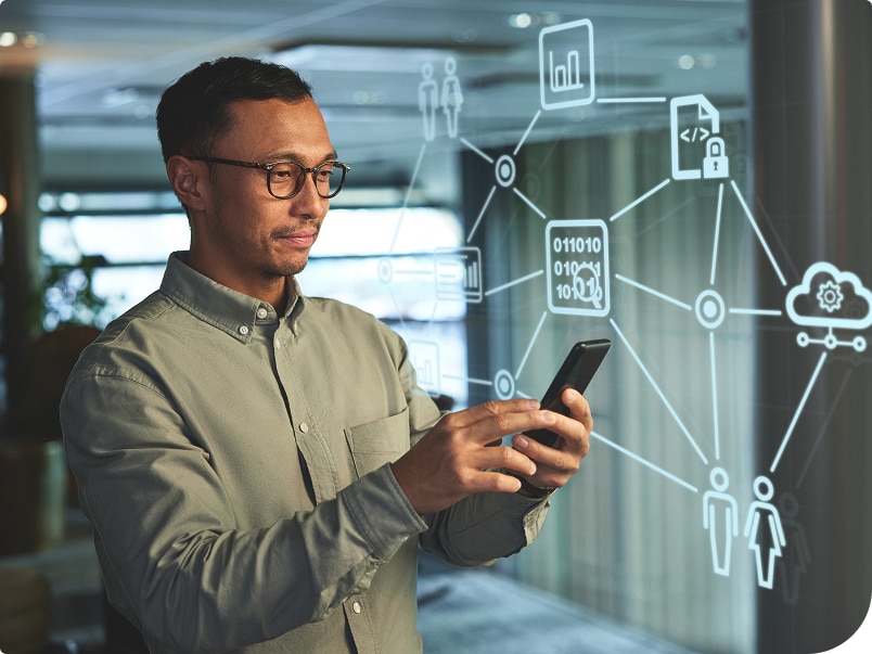 A facility manager using a smartphone with digital network and data icons displayed in the background A facility manager using a smartphone with digital network and data icons displayed in the background