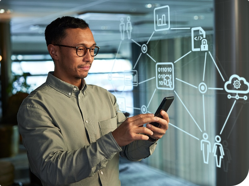 A facility manager using a smartphone with digital network and data icons displayed in the background A facility manager using a smartphone with digital network and data icons displayed in the background