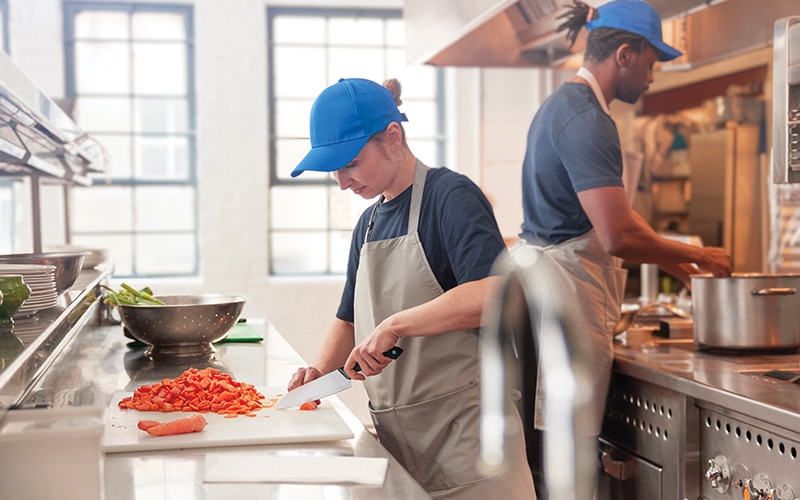 Two chefs preparing food in a professional restaurant kitchen Two chefs preparing food in a professional restaurant kitchen