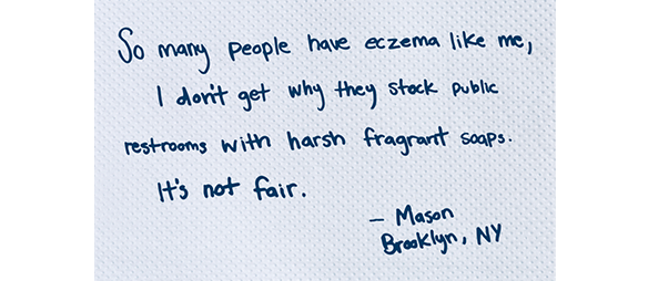 A Tork paper towel which has a hand-written letter on it explaining how skin conditions barriers can make it hard to use public restrooms 