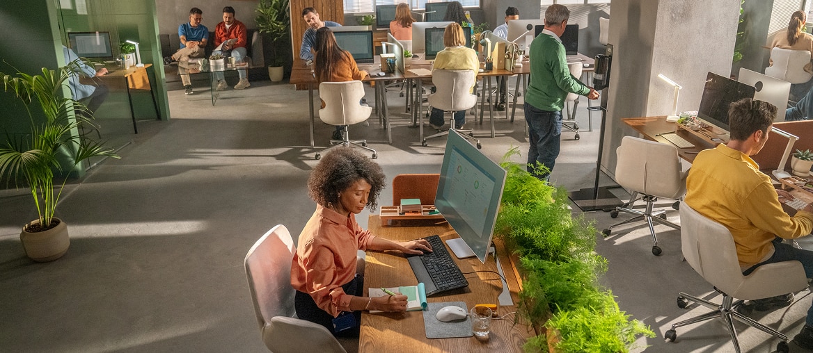 Wide view of busy office with people working