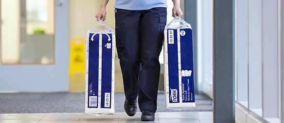 Cleaning staff carrying packaging with both hands​