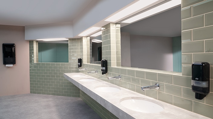 Wide view of office restroom with dispensers