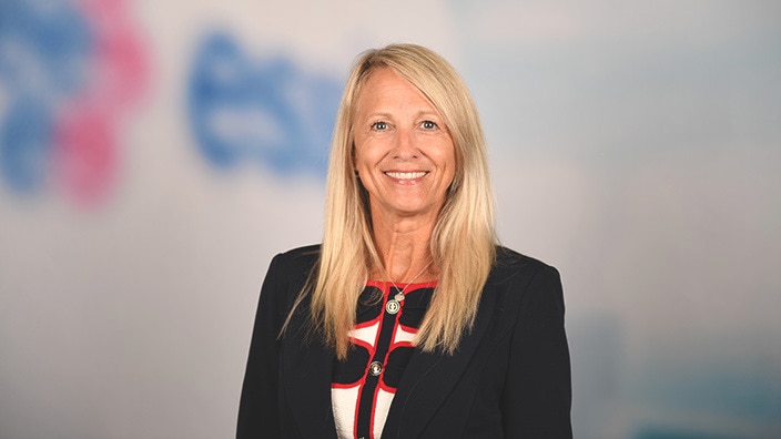 Headshot of a woman smiling in a professional setting