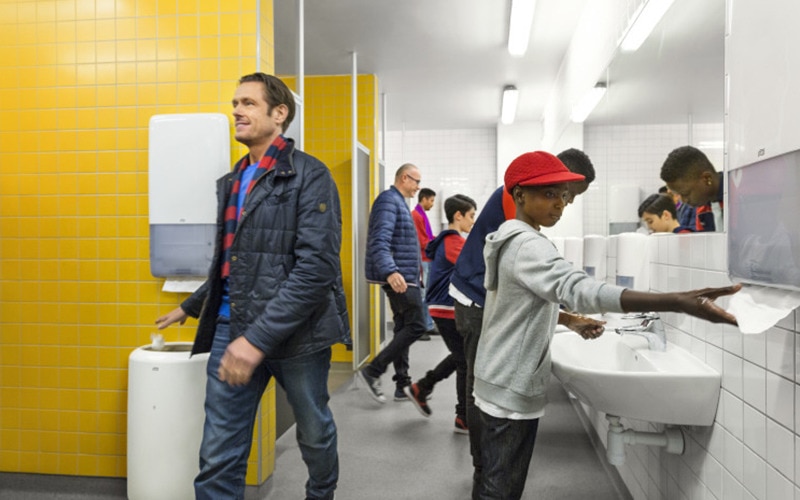 Men and boys in a busy washroom