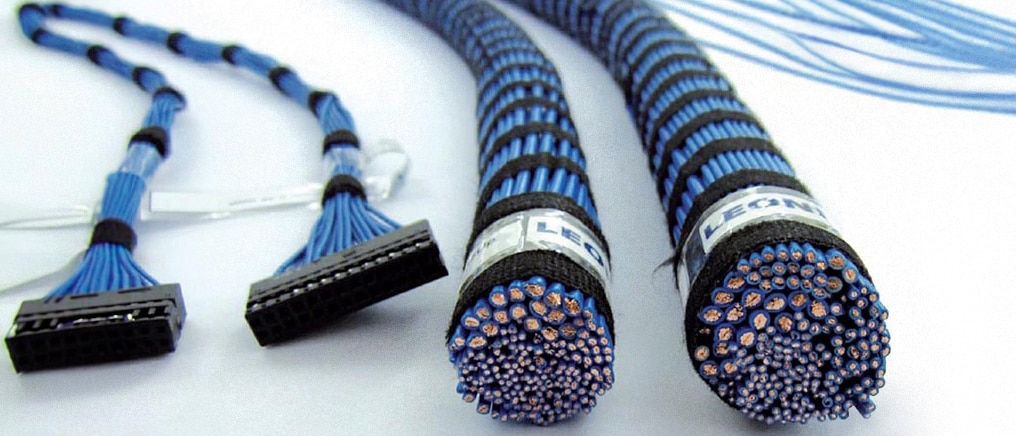 Bundled electrical cable harnesses with blue wires and black connectors on a white background.