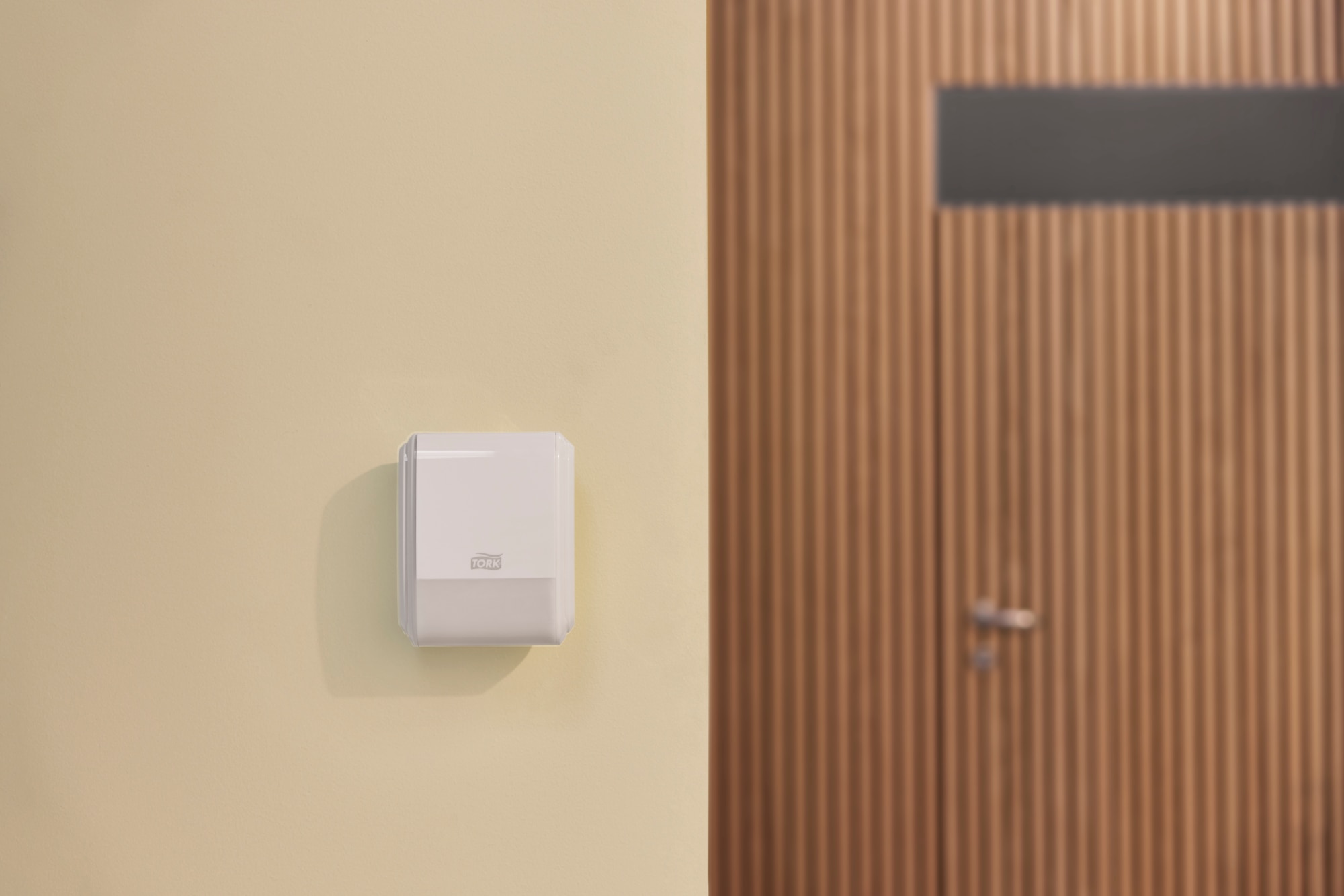 Tork Constant Air Freshener on a wall