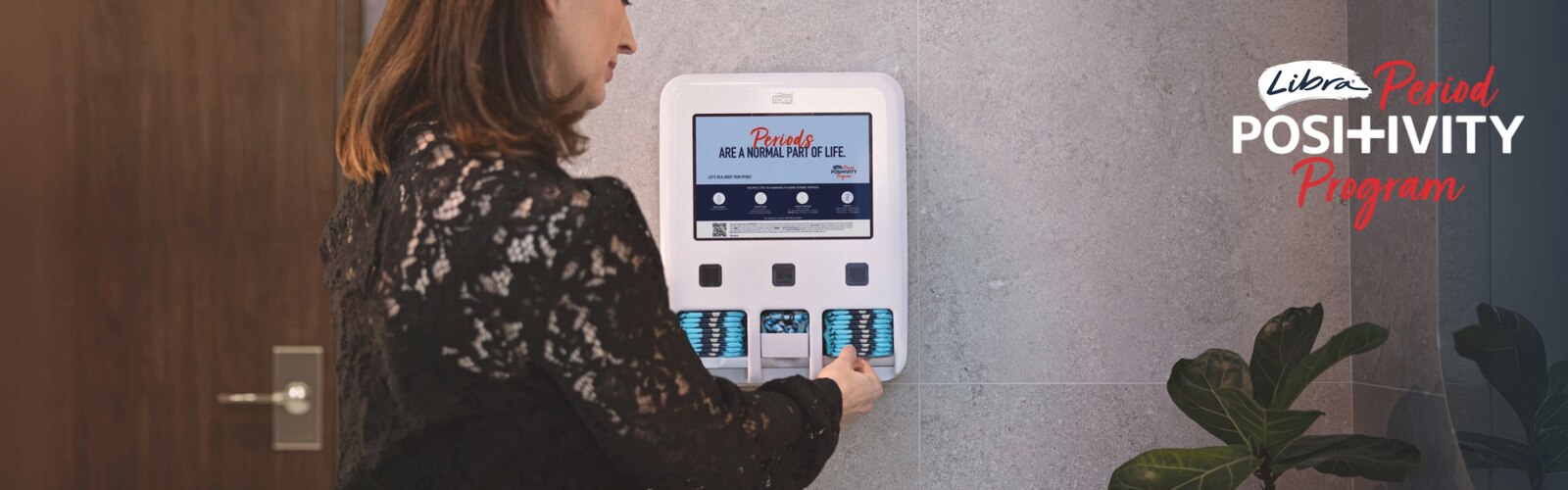 Woman taking pad from Libra Period Positivity Program dispenser