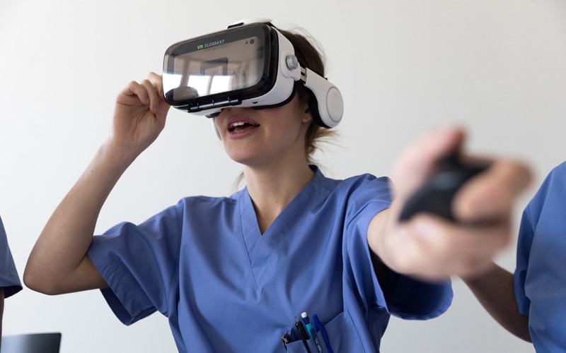 A nurse wearing virtual reality goggles