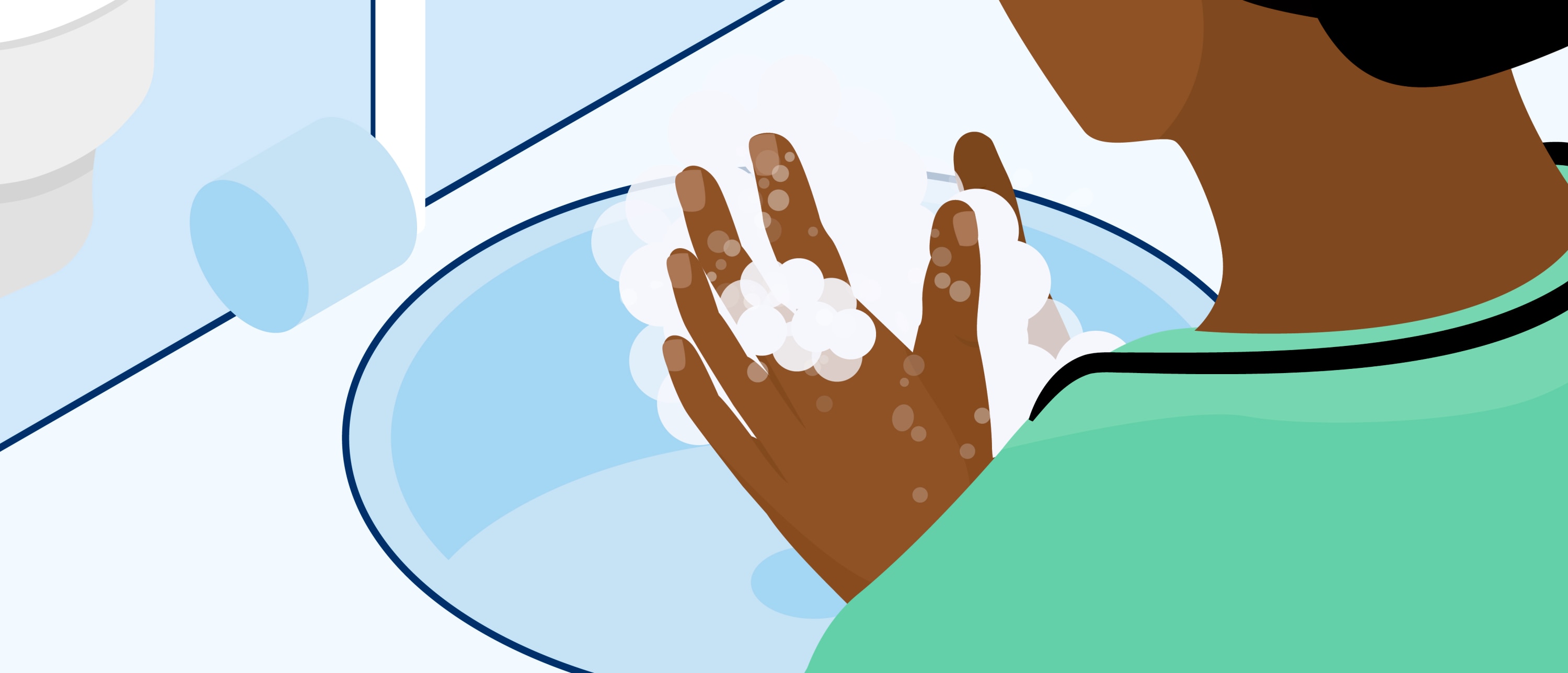 Close-up from behind of a person washing their hands over a sink, with palms and fingers covered in soap lather.