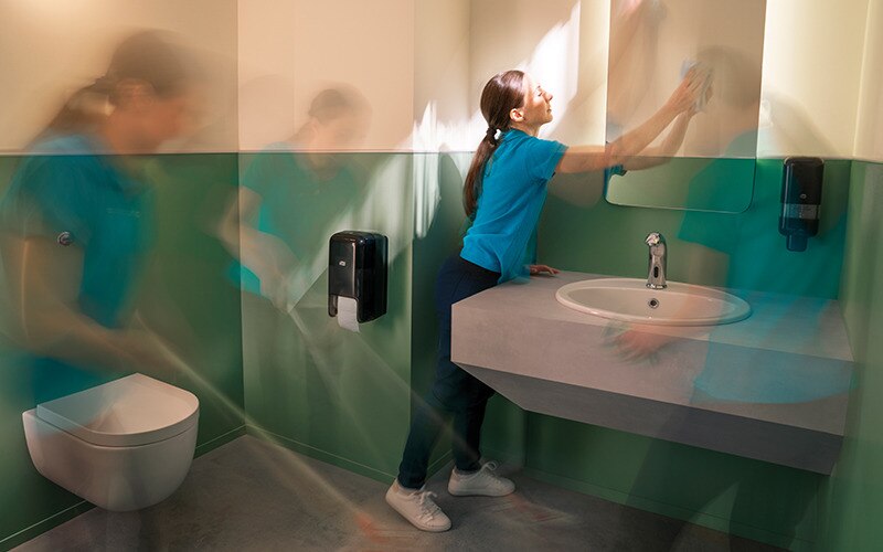 a female cleaning staf is cleaning a restroom - timelapse